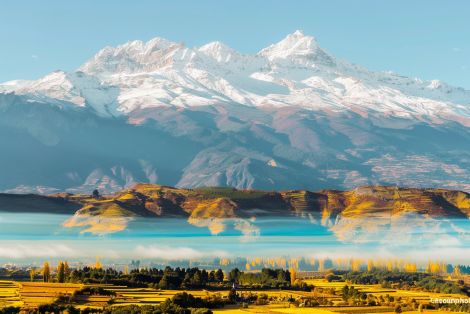 Golden Valley Beneath Snow Capped Peaks